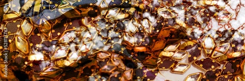 Gold marble aand golden gems on Alcohol ink fluid abstract texture fluid art with gold glitter and liquid.
