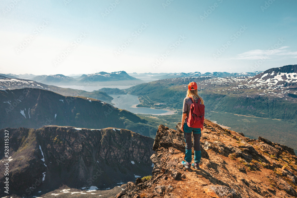 Woman hiking in Norway enjoying aerial view on cliff outdoor Travel adventure tour active vacations healthy lifestyle climbing to Hamperokken mountain sustainable tourism Woman hiking in Norway enjoying aerial view on cliff outdoor Travel adventure tour active vacations healthy lifestyle climbing to Hamperokken mountain sustainable tourism