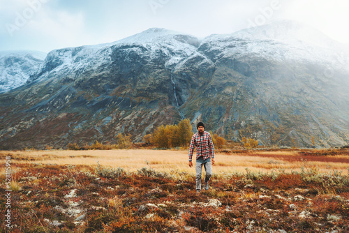 Hiking expedition man exploring autumn mountains in Norway active healthy lifestyle adventure vacations eco tourism scandinavian nature Jotunheimen park