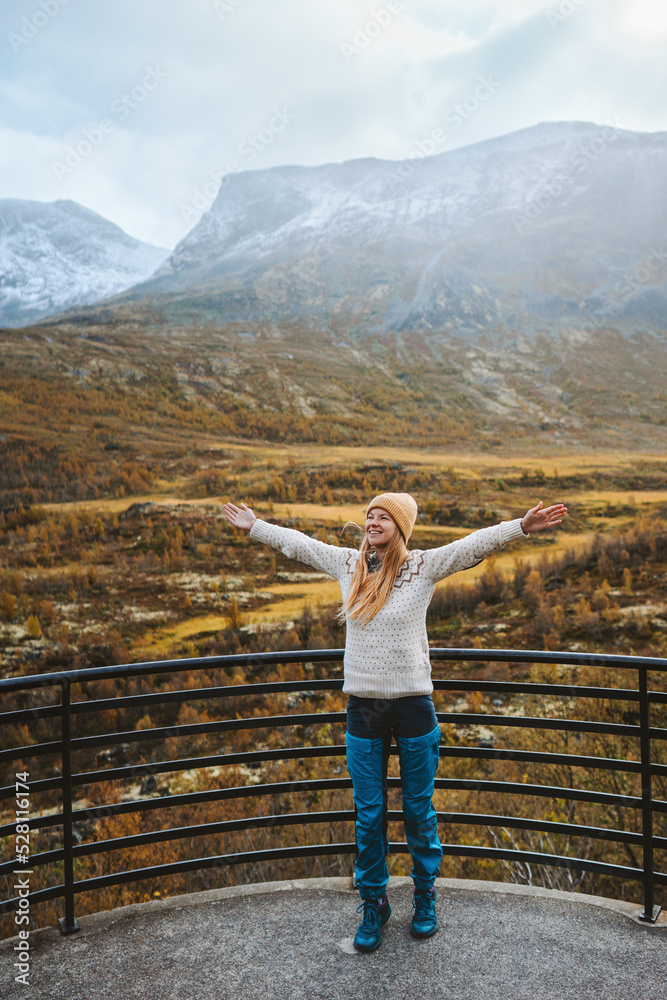 Happy woman traveling outdoor in mountains of Norway active healthy lifestyle scandinavian nature autumn season Jotunheimen park viewpoint