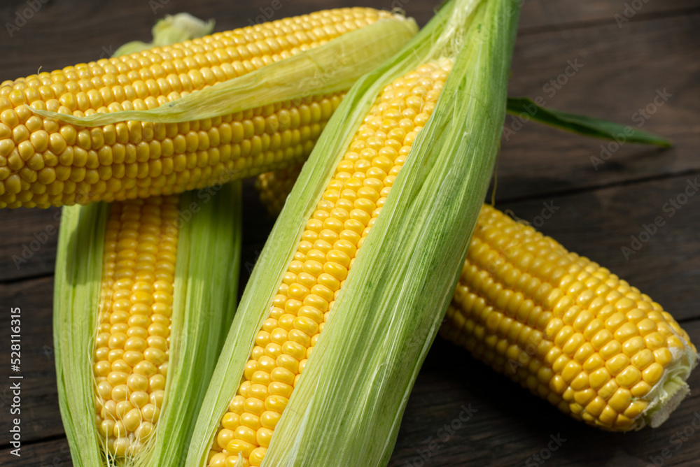Fresh corn on cobs on rustic wooden table, closeup. Top view with copy space Fresh corn on cobs on rustic wooden table, closeup. Top view with copy space