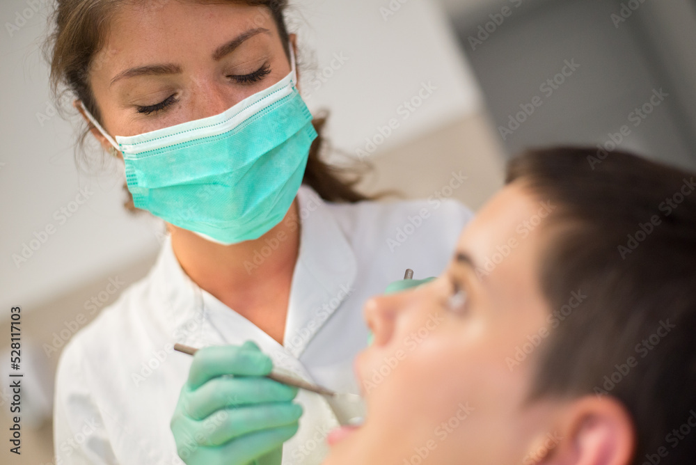 Young woman checking her teeth at the dentist clinic Young woman checking her teeth at the dentist clinic