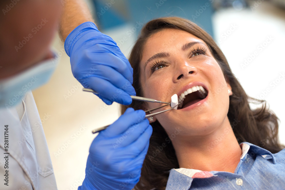 Young woman checking her teeth at the dentist clinic Young woman checking her teeth at the dentist clinic