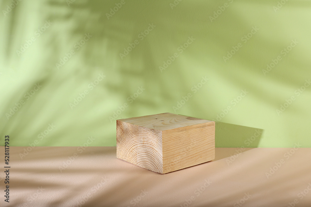 Minimal abstract background for the presentation of cosmetic products. Premium empty podium with shadows of tropical palm leaves on light wall and wooden stand, template for design, pedestal podium, Minimal abstract background for the presentation of cosmetic products. Premium empty podium with shadows of tropical palm leaves on light wall and wooden stand, template for design, pedestal podium,