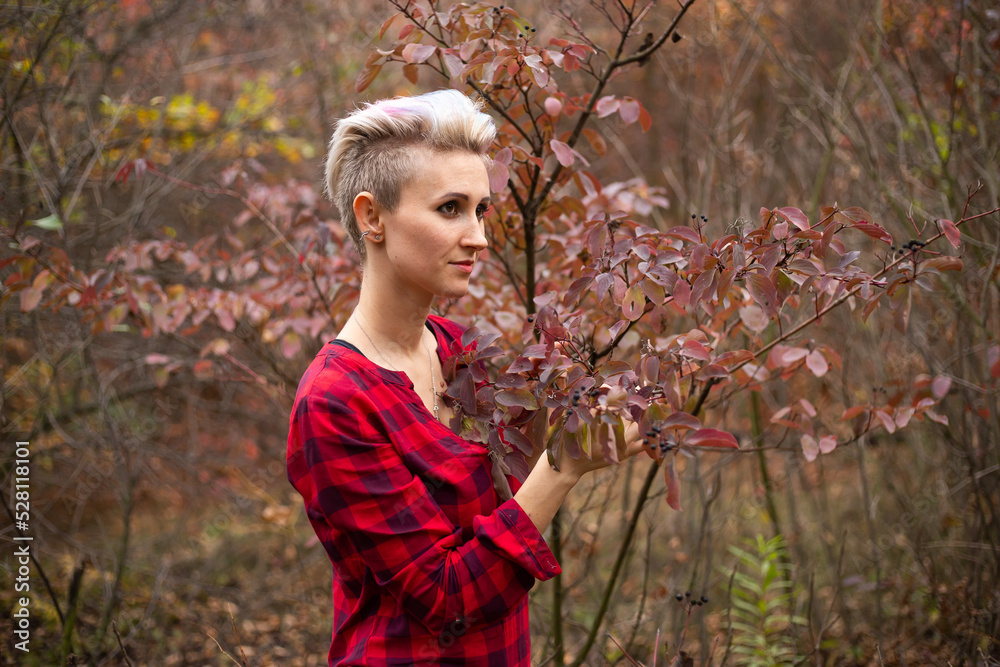 portrait of stylish hipster woman with short haircut in autumn background with withered autumn trees portrait of stylish hipster woman with short haircut in autumn background with withered autumn trees
