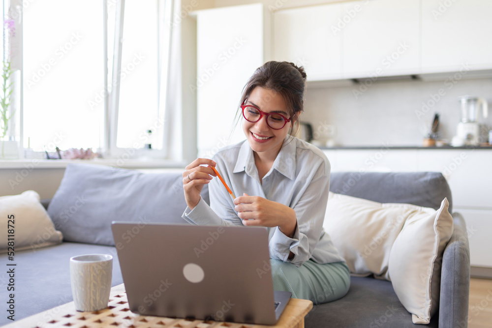 Happy woman in glasses tutor conduct educational webinar on laptop. Smiling teacher freelancer holding video call with students, explaining foreign language. Distant education, e-learning. Happy woman in glasses tutor conduct educational webinar on laptop. Smiling teacher freelancer holding video call with students, explaining foreign language. Distant education, e-learning.