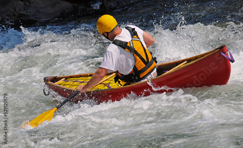 Man in a canoe in rapids