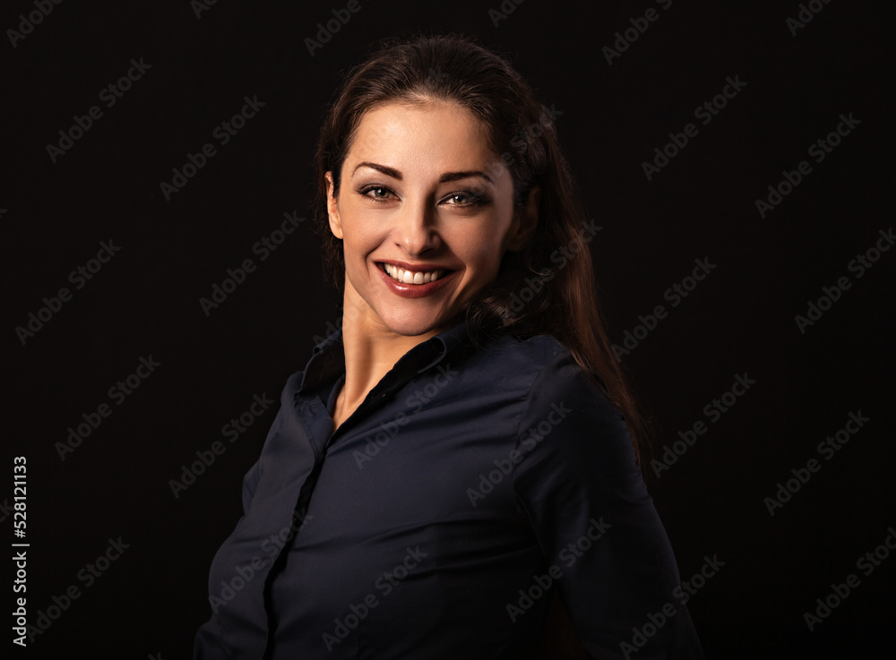 Beautiful thinking toothy smiling business woman looking in blue shirt on black background with empty copy space for text. Closeup Beautiful thinking toothy smiling business woman looking in blue shirt on black background with empty copy space for text. Closeup