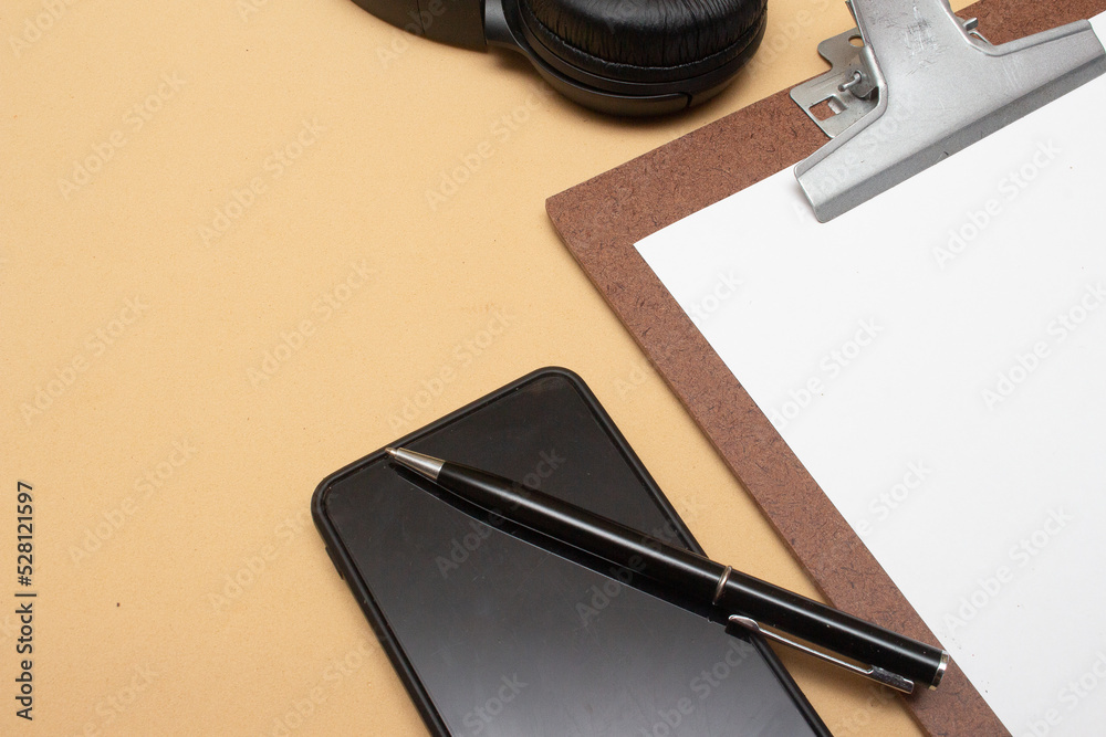 smartphone and clipboard on office table smartphone and clipboard on office table