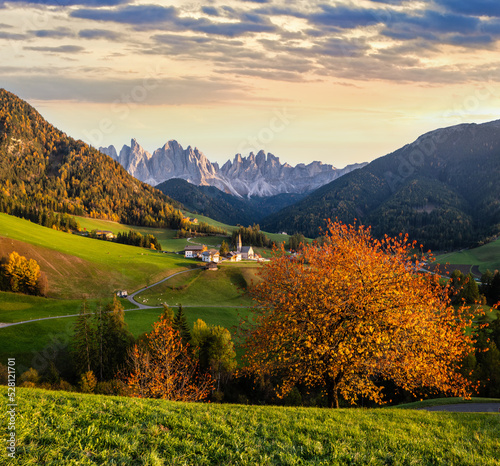 Autumn evening Santa Magdalena famous Italy Dolomites village view. Picturesque traveling and countryside beauty concept background.