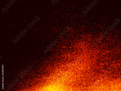 Particles of embers of fire on a black background. Fire sparks background. Abstract lights of dark glitter fire particles.