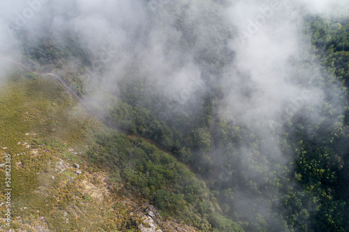 Aerial view of a mountain cliff in foggy weather