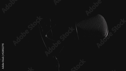 Professional studio microphone on an anti vibration stand, being side lit