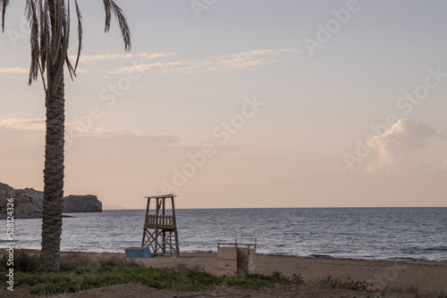 Lifeguard tower on a greek beach at sunset. Empty beach in winter