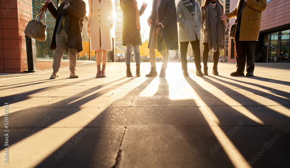 Silhouette of a group of unrecognizable business people full body talking outdoors in the city street. Silhouette of a group of unrecognizable business people full body talking outdoors in the city street.