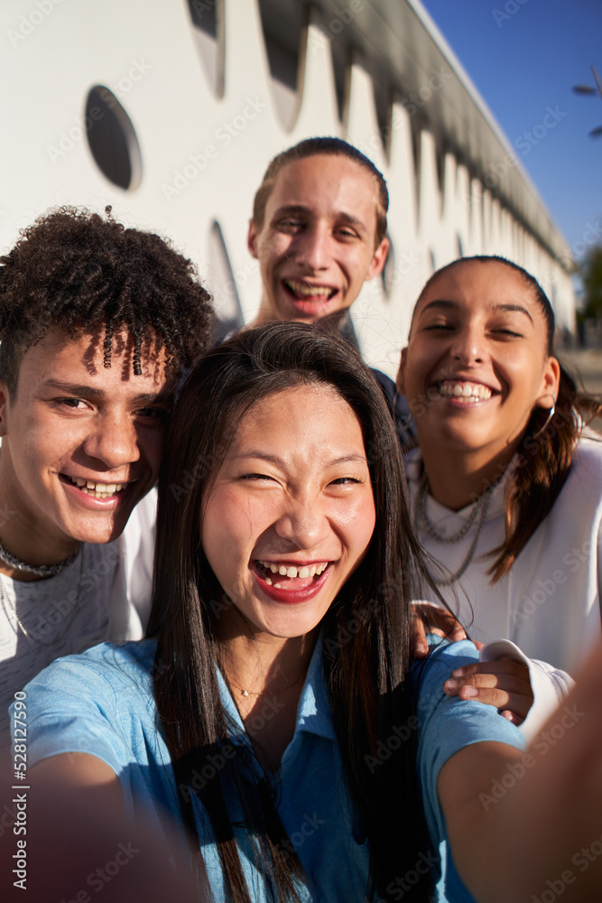 Vertical photo of a Chinese girl taking a selfie with a multiracial ...