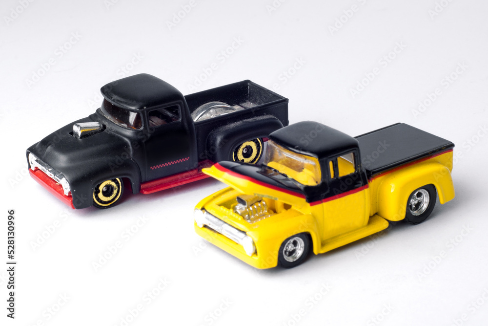two trucks toy black and yellow with white background two trucks toy black and yellow with white background