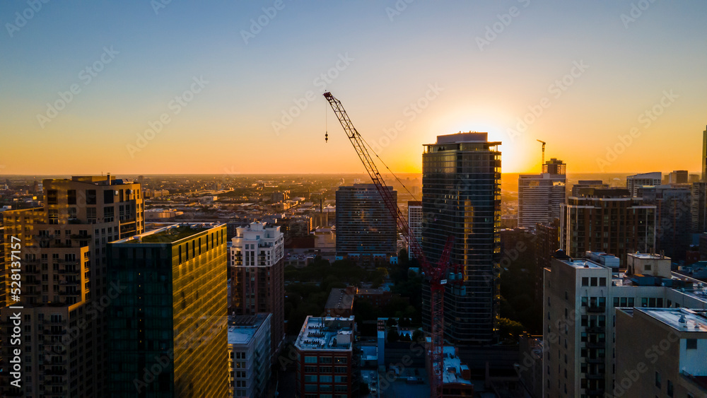 Obraz premium Chicago, IL USA September 1 2022: establishing aerial drone footage of Chicago downtown during sunset on a mid summer evening. the contemporary buildings are beautiful to watch for tourist 