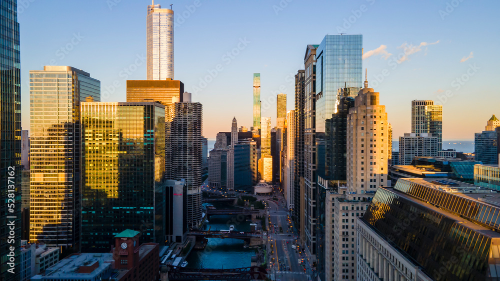 Obraz premium Chicago, IL USA September 1 2022: establishing aerial drone footage of Chicago downtown during sunset on a mid summer evening. the contemporary buildings are beautiful to watch for tourist 