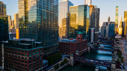 Chicago, IL USA September 1 2022: establishing aerial drone footage of the Chicago downtown train over the lake water during sunset. the city always moving during the course of the day