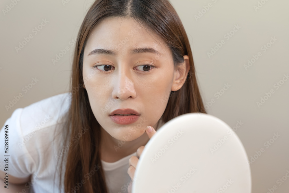 skin problem treatment. Women looking acne on her face in the mirror. skin problem treatment. Women looking acne on her face in the mirror.