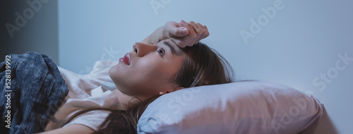 Obraz na płótnie Asian women opened eyes lying on the bed have an insomnia problems