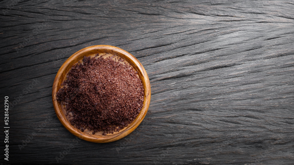 Hawaiian red salt on wooden surface Hawaiian red salt on wooden surface