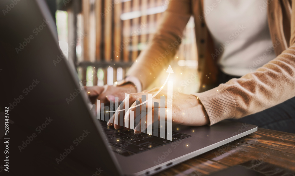 Female hands typing on laptop with business finance technology graph icon. Businesswoman analyzing financial data and forex trading charts. Technology concept