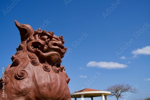 Statue of Shisa and blue sky scenery photo