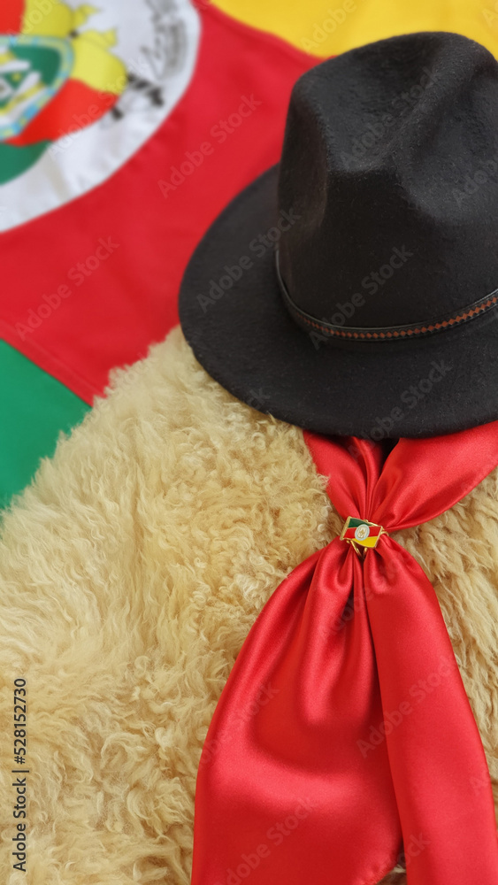 Gaucho hat and scarf, over the flag of the State of Rio Grande do Sul, Brazil and rustic background. Gaucho hat and scarf, over the flag of the State of Rio Grande do Sul, Brazil and rustic background.