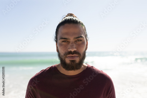 Young mixed race man portrait on the beach