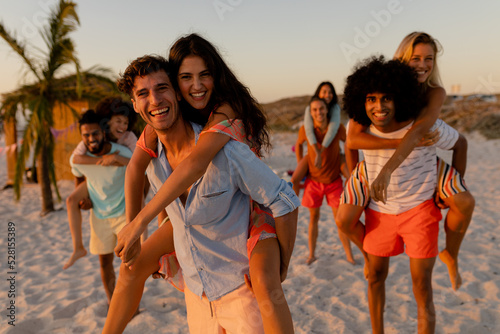 Mixed race friends having fun on beach #528155389
