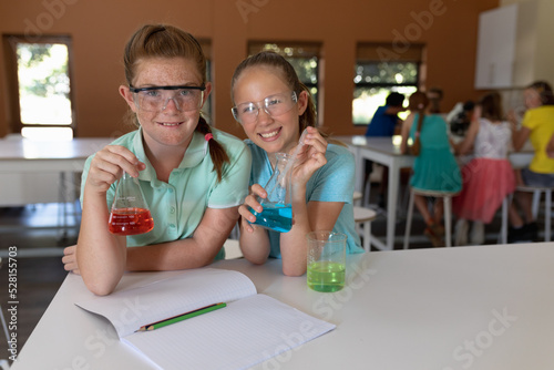 Two elementary school girls in chemistry class