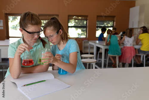 Two elementary school girls in chemistry class