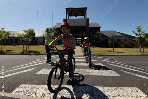 Woman wearing a high visibility vest and holding a stop sign