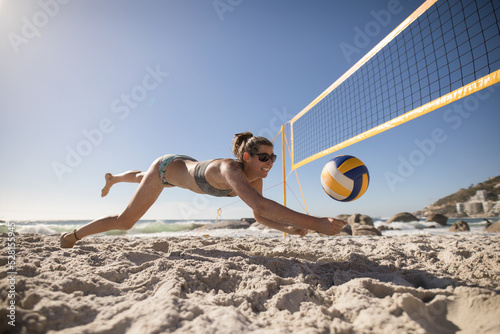 Female volleyball player playing on the beach