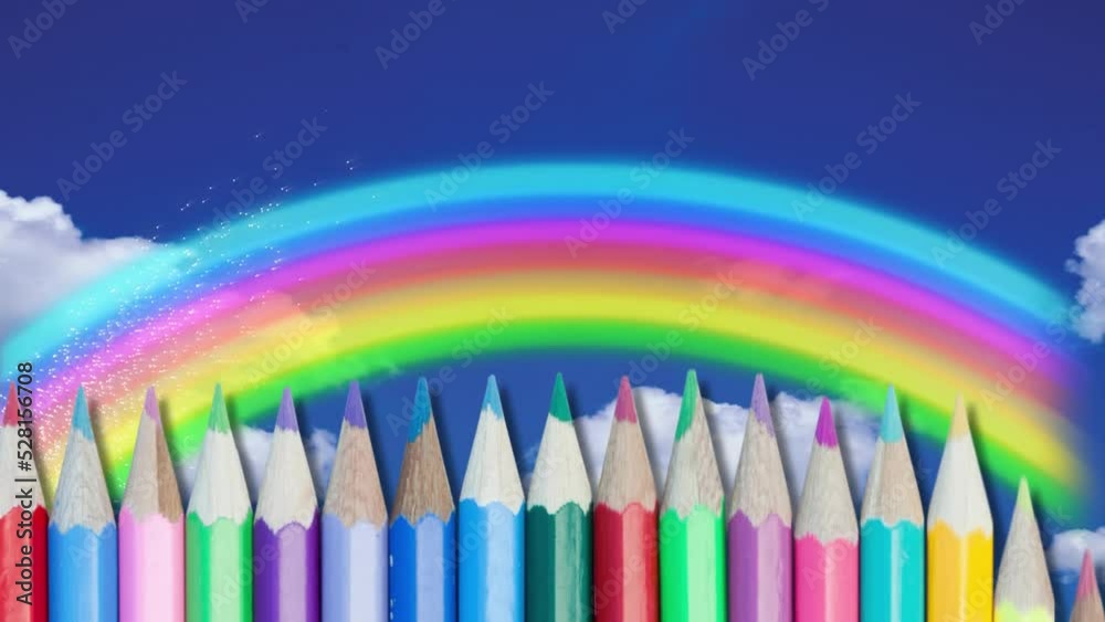 Multiple colored pencils against rainbow on blue sky