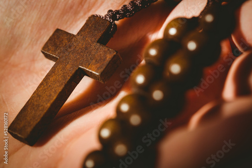 Hand holding rosary beads