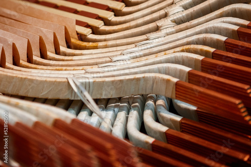 Electric motor stator under assembly. Thick copper busbars are wrapped with insulating cloth photo