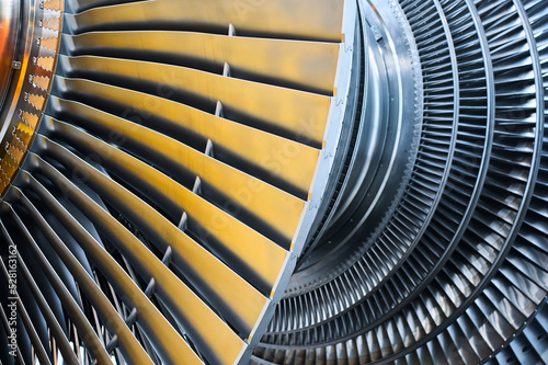 Shiny rotor of powerful steam turbine in light workshop