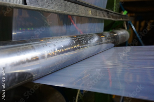 LDPE. extrusion blown film machine showing bubble extruded from die head through bubble stabilizer and steel roller.