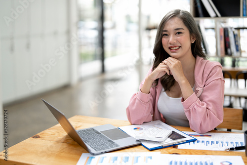 Portrait of a happy businesswoman working at her office desk