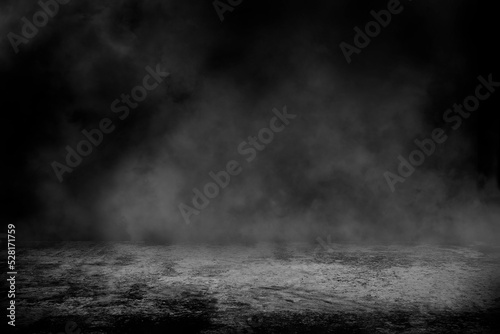 Concrete floor with smoke or fog in dark room with spotlight. asphalt street  black background