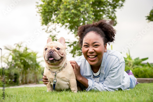 Bulldog with owner spend a day at the park playing and having fun on grass in the garden. Animals and people on allergy season concept. Learning and play