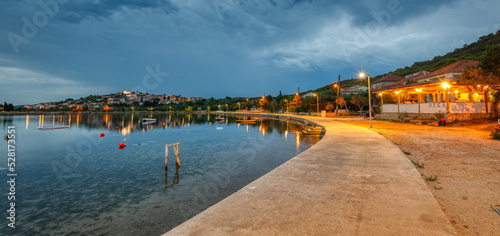 Promenade along the shore in the evening on Vrgada photo