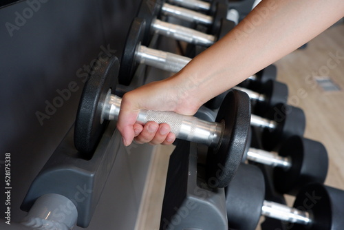 Dumbbell exercises in the gym health and fitness concept.