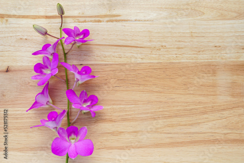 bouquet of purple orchids on wooden table background. Soft and selective focus.