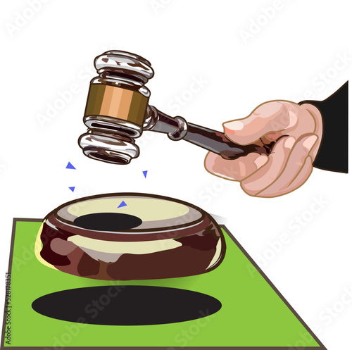 a hammer hits the anvil on the green table

