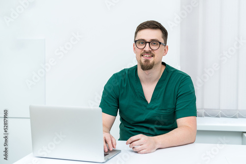 Healthcare modern hospital doctor with laptop. Professional medical specialist working with computer.