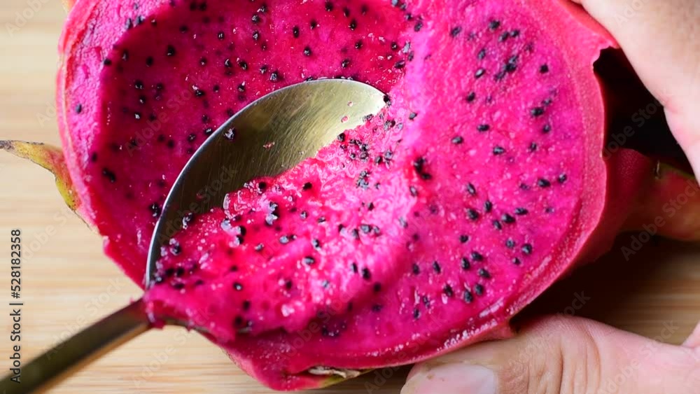Golden spoon scooping fruit, food, dragon fruit, pink flesh, close-up video